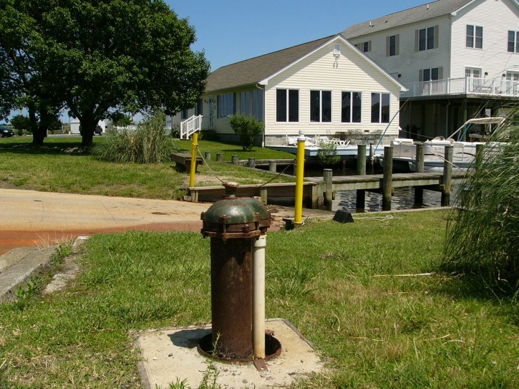 Photo of a drinking water well located next to a canal
