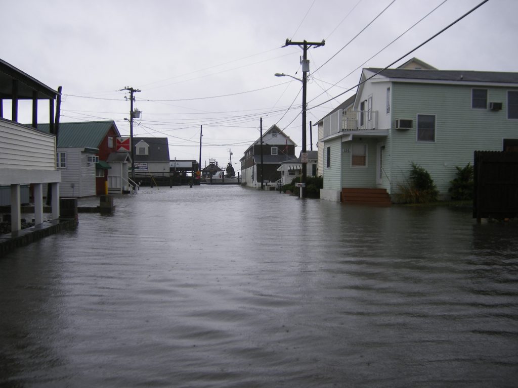 Flood waters completely cover a street in a beach-front town.