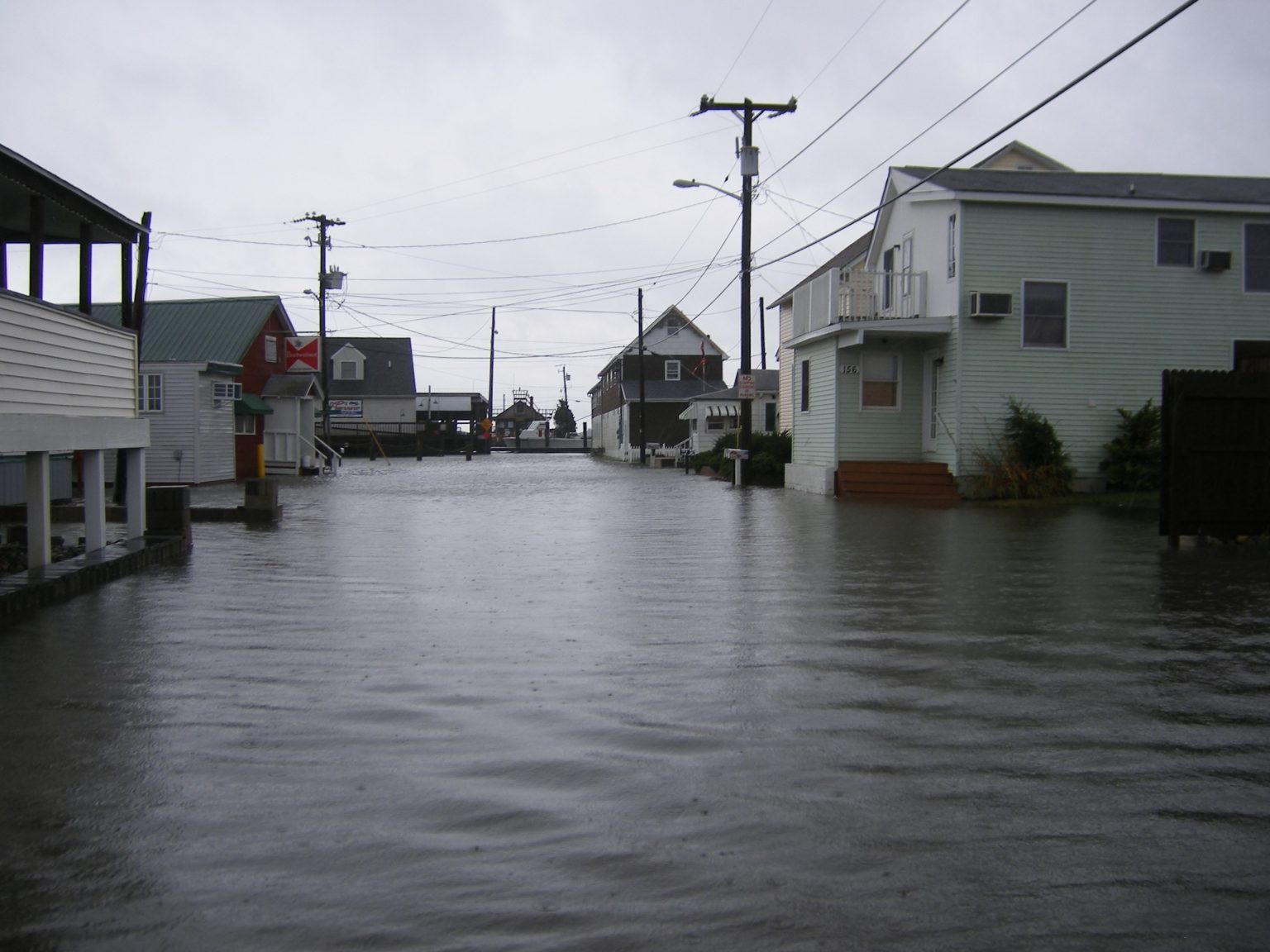 A flooded residential street in a beach town.