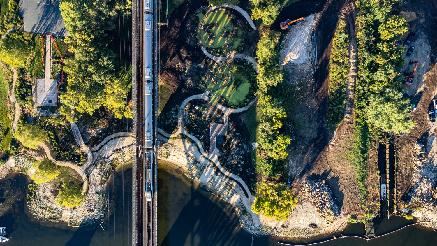 Aerial view of a shoreline with parklands, a bridge and healthy beach and vegetated shoreline habitats.