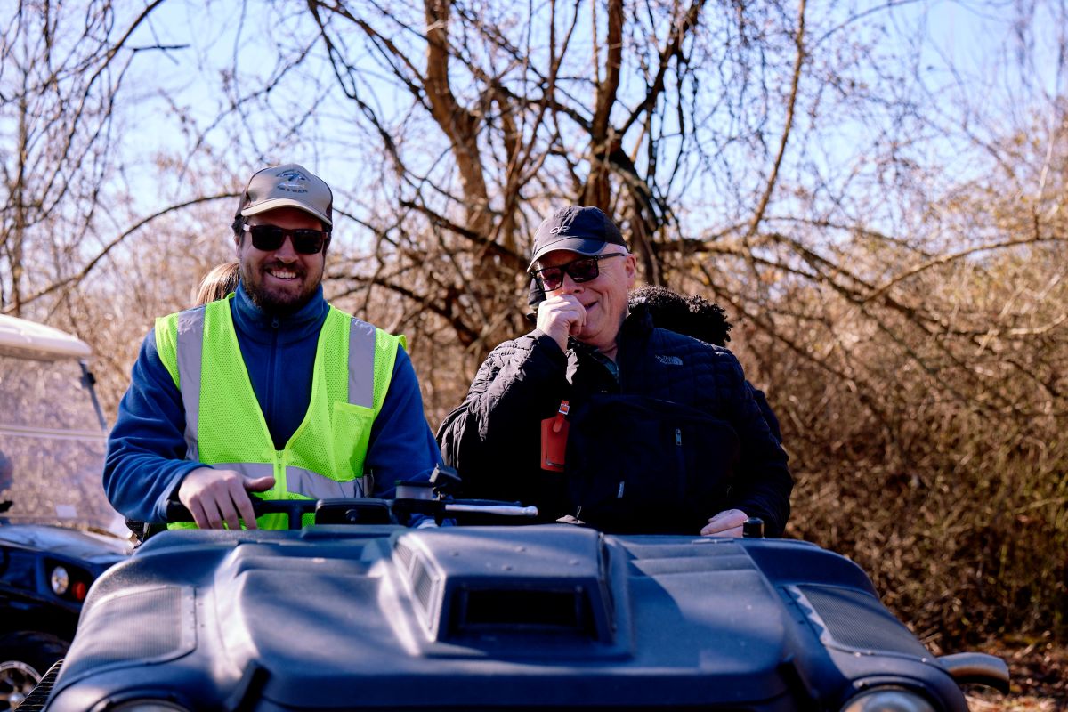 Two men in an off-road vehicle.