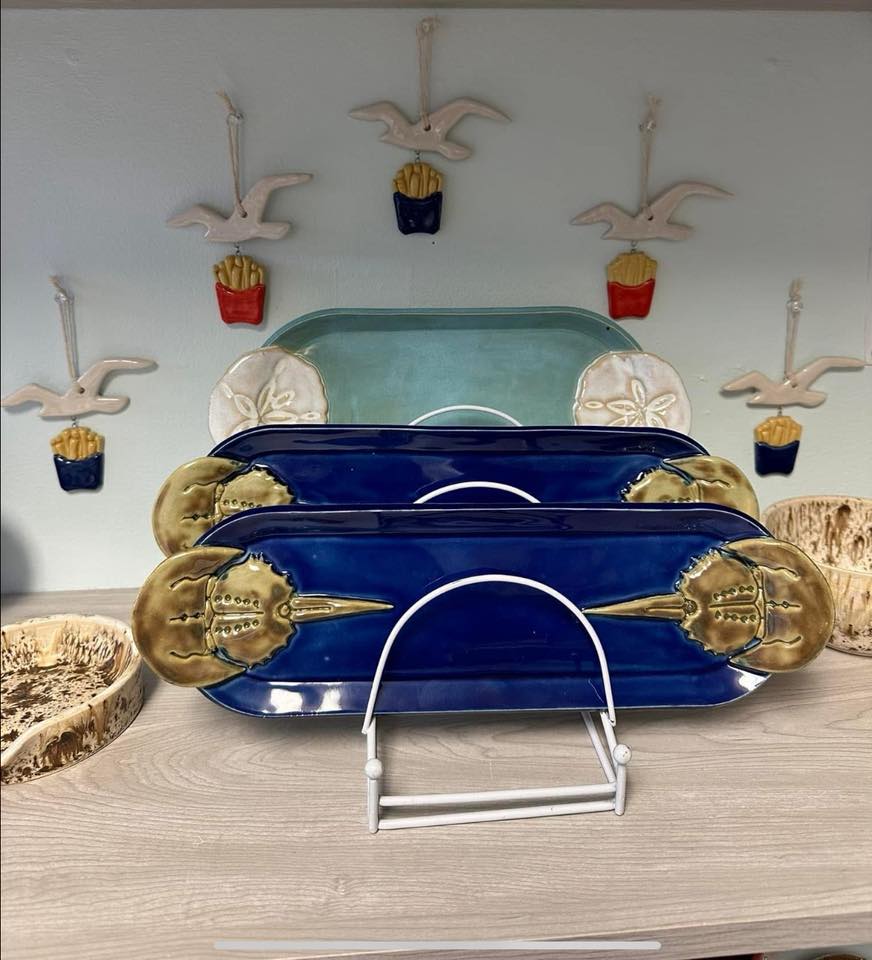 Several horseshoe crab-themed trays sit on a counter.