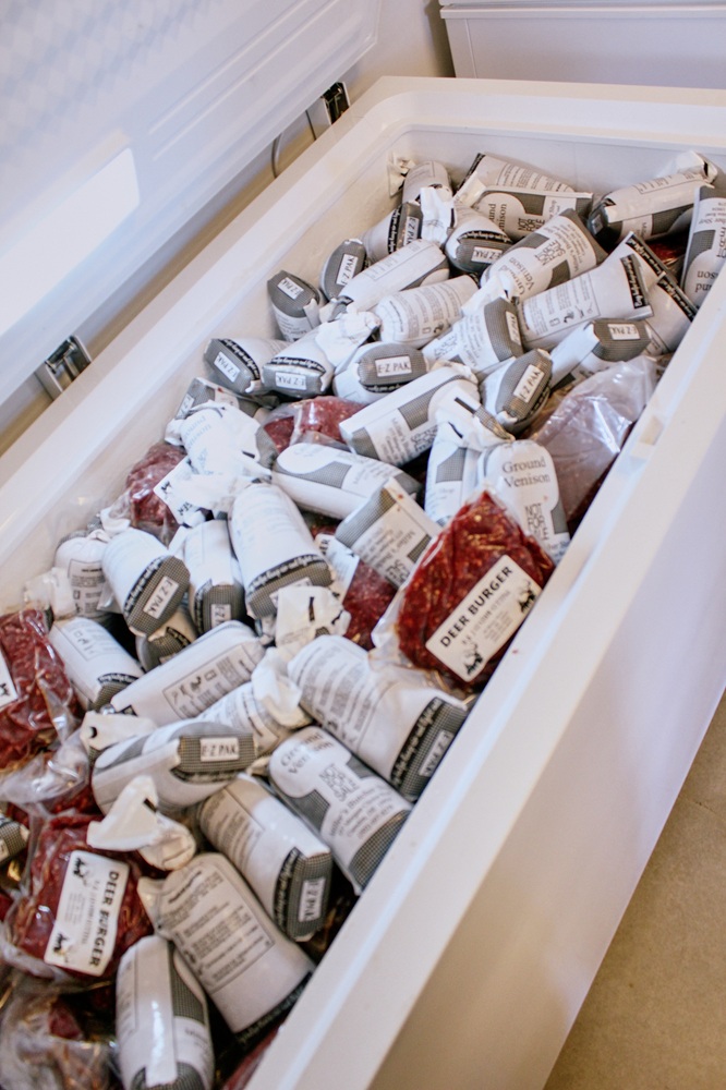 Deer meat sits in a cooler.