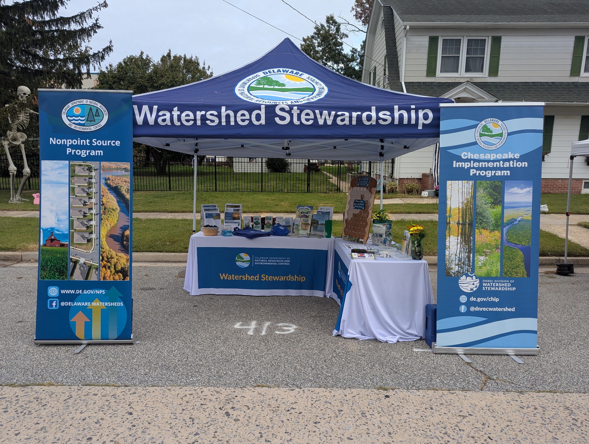 A blue tent, with "Watershed Stewardship" written on it, set up as a display.