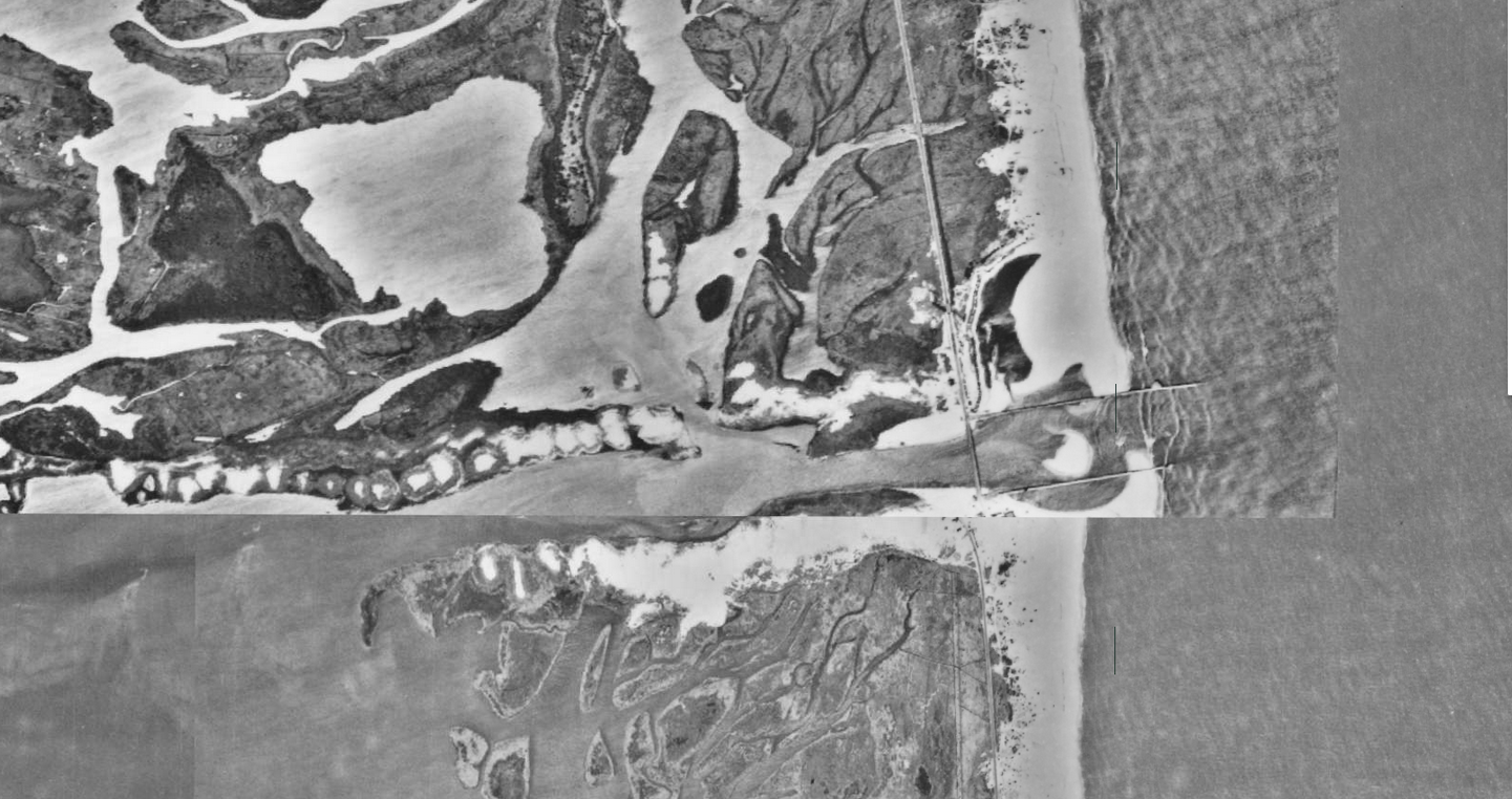 An aerial image, from historic photos, of a roughly dredged inlet connecting the ocean and inland bays.