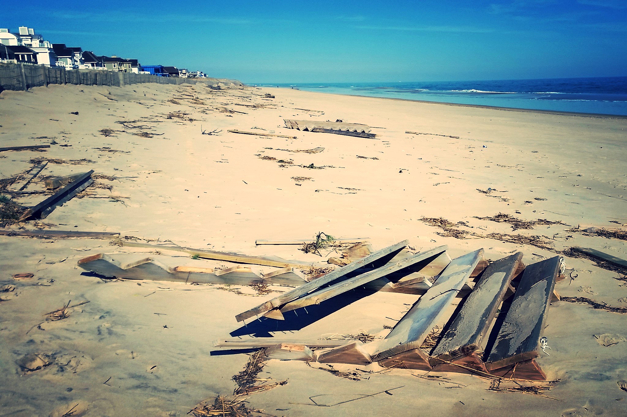 The remains of beach cross-over steps lie shattered on a beach after a storm.